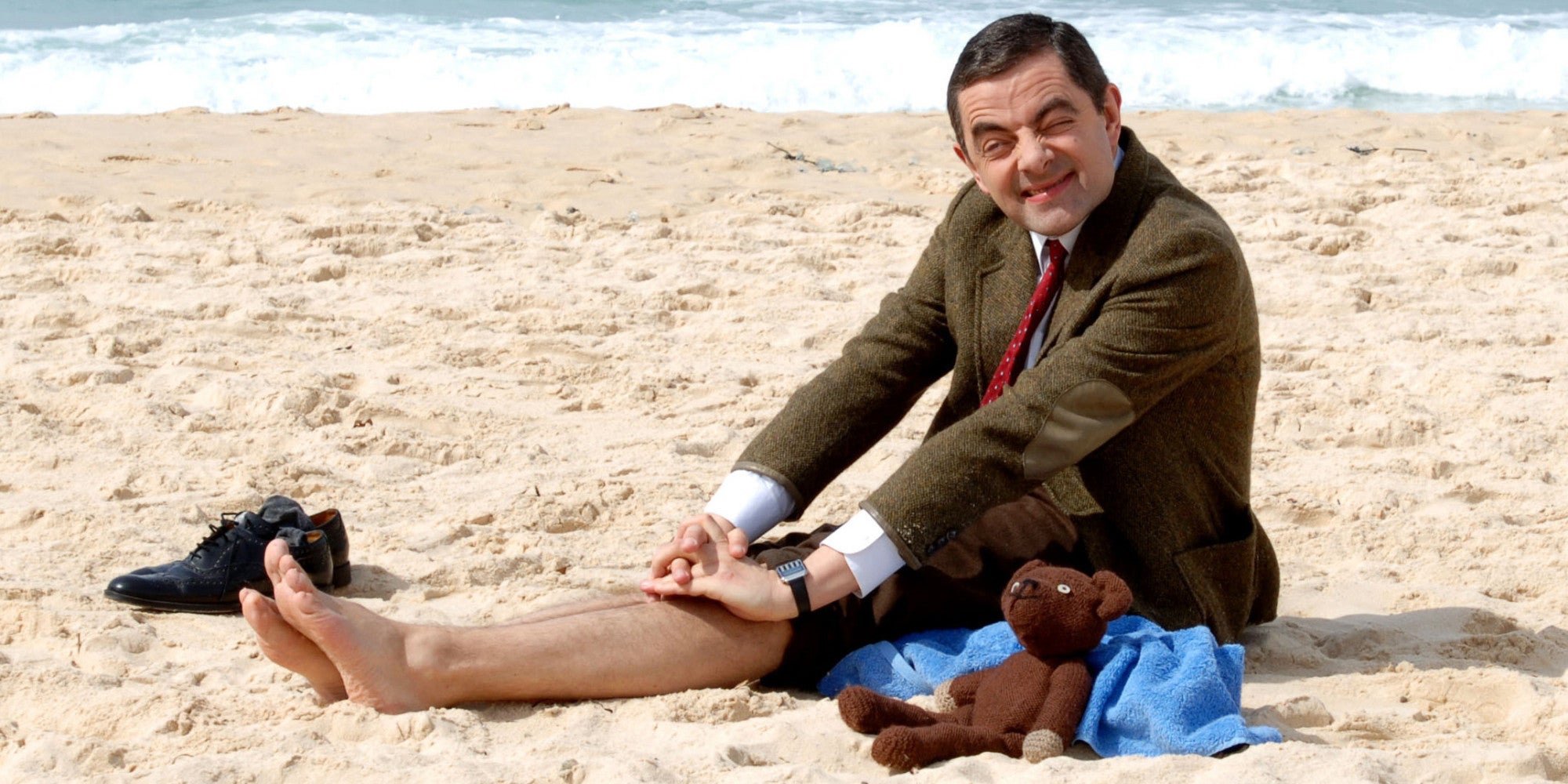 British comedian Rowan Atkinson as his alter ego Mr. Bean poses for photographs as he sits on the sand at Bondi Beach in Sydney, Wednesday, March 7, 2007. Atkinson is in Australia to promote the opening of his new film "Mr. Bean's Holiday." (AP Photo)