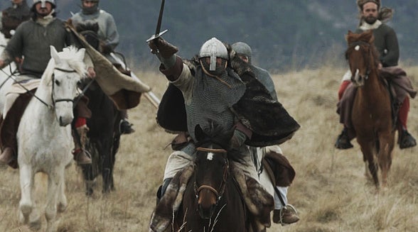 Balian (Orlando Bloom, center, with sword raised) and Almaric (Velibor Topic, to Blooms left) lead the charge into battle against the Saracens.