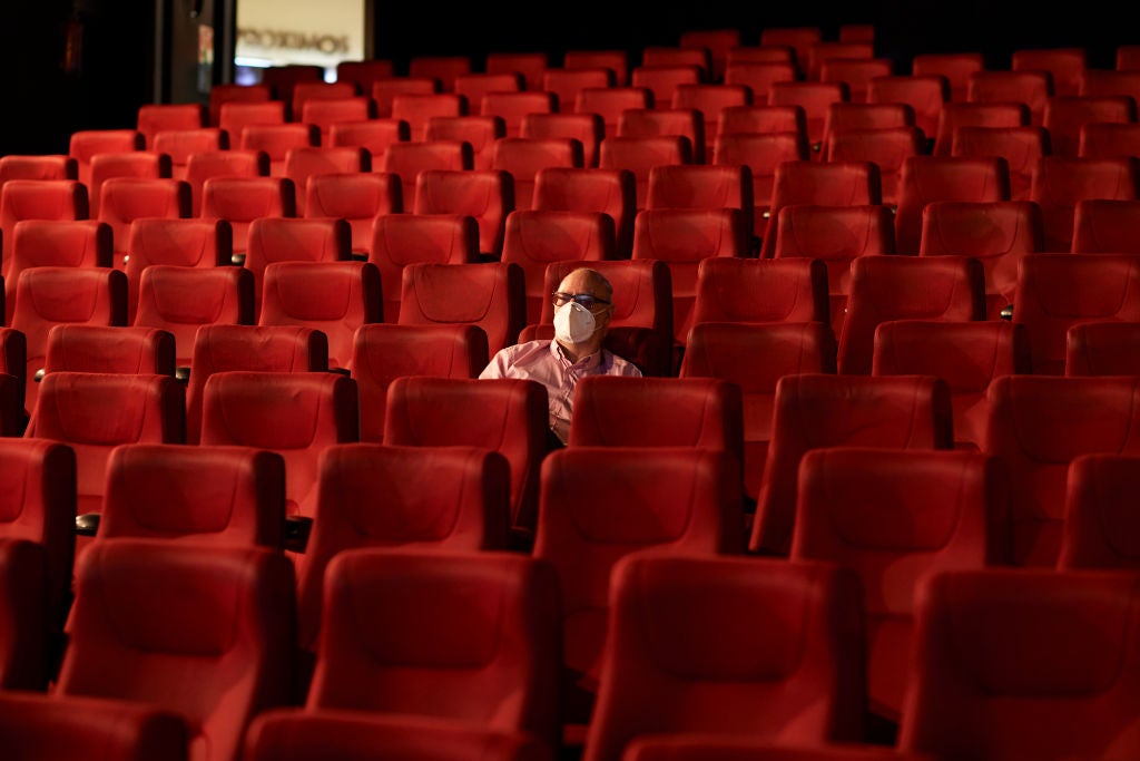 MADRID, SPAIN - JUNE 12: A man wearing a face mask waits for the beginning of the film in the Capitol cinema on June 12, 2020 in Madrid, Spain. The Capitol cinema reopens with a 20% capacity in each of its screening rooms after its closure in the middle of March, because of the Covid-19 pandemic. Spain has largely ended the lockdown it imposed to curb the spread of Covid-19, which caused the death of more than 27,000 people across the country. This week all regions are on Phase One or Two, one month after all of Spain started on Phase zero on May 4, 2020. (Photo by Carlos Alvarez/Getty Images)